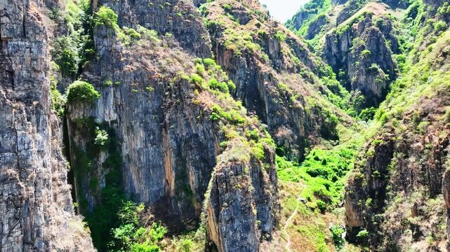 Steep Rocky Canyon Cliffs with Green Vegetation