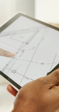 Hands, tablet screen and blueprint for renovation planning, construction or interior design of home. Architecture, review floorplan or layout with person, digital drawing or house remodeling project