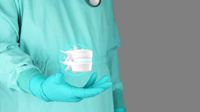 Doctor in green uniform presents a 3D herniated disc. Concept of spinal health, physiotherapy and rehabilitation, nerve root compression, awareness of disc degeneration and lumbago. Isolated.