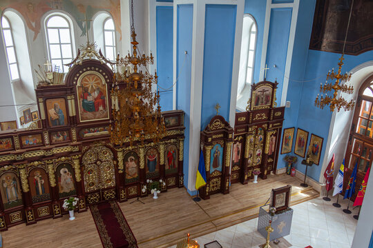 Elevated view of orthodox church nave, iconostasis and chandelier