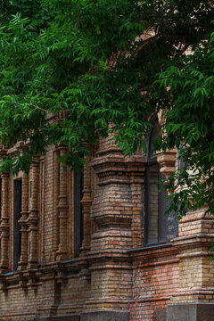 Decorative brick pilasters of a historic building under summer canopy 