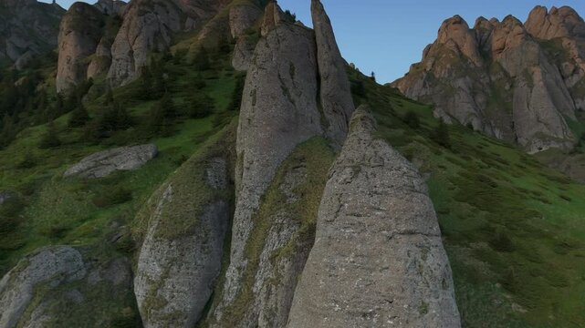 Superb detailed close up of Tigaile Mari erosion towers texture during golden hour, low altitude ascending drone flight, Ciucas Mountains, graded