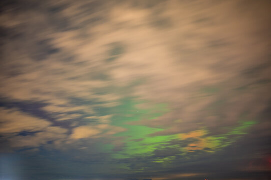Aurora Borealis Behind Moving Clouds