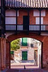 Naklejka premium Framed View of Town Streets via Plaza Mayor Arch
