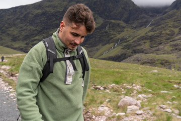Man wearing fleece jacket hiking in scottish mountains © Cavan