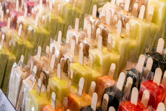 Rows of colorful wrapped ice pops on display