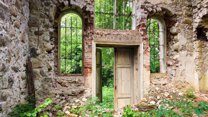 Naklejka premium Ancient Arched Windows in Forest Ruins