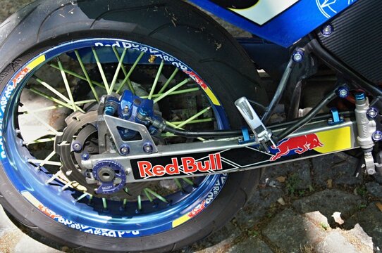 Motorcycle rear wheel showing brake disk and Red Bull branding. Enduro Race World