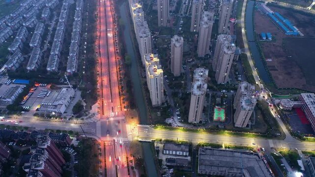 Aerial View of Residential Apartment Towers and Illuminated Boulevard at Dusk