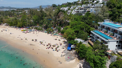 Fototapeta premium Aerial View of a Tropical Beach with Resorts and Turquoise Water in Phuket