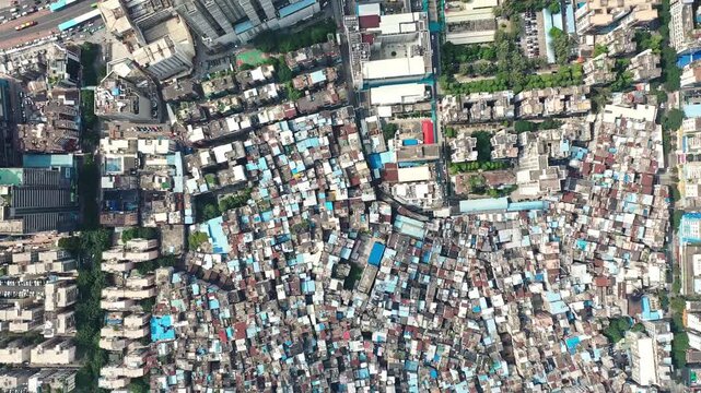 Aerial view of dense urban informal settlement surrounded by high rise buildings