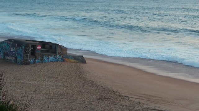 Static shot of a World War II concrete bunker covered with graffiti on the beach at Labenne-Ocean, Landes, France