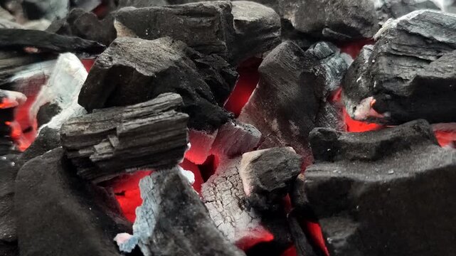Hot burning charcoal with red embers and white ash. A stable, efficient, and smoke-free heat source, this charcoal is ideal for domestic, culinary, and industrial use