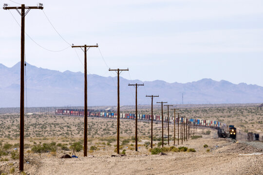 Freight train winds through arid mountain landscape