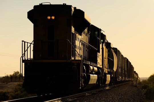 Diesel locomotive train traveling during golden hour