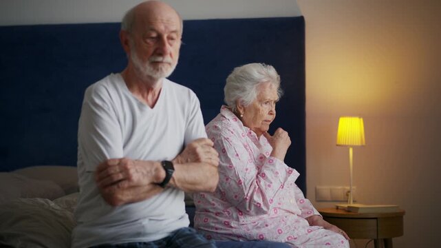 Senior couple with relationship problems, having argument in bedroom.