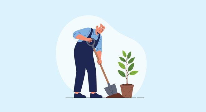 Hardworking elderly man in blue overalls uses a large shovel to dig a planting hole for a young tree in a pot.