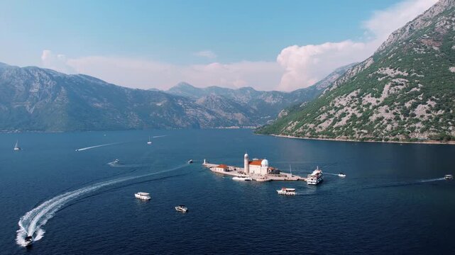 Passenger boats glide towards scenic coastal island destination