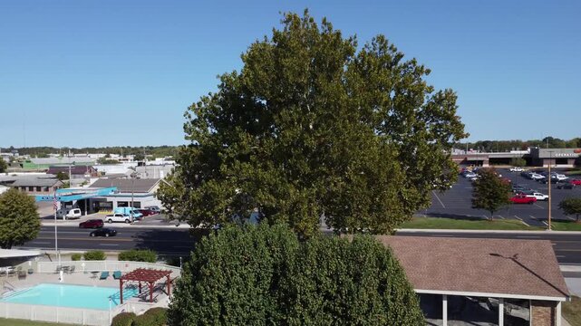 Drone footage rising above a historic Route 66 property in Springfield, Missouri, revealing nearby businesses, traffic, and the surrounding cityscape.
