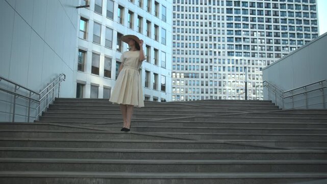 Woman standing on urban steps in bright daylight