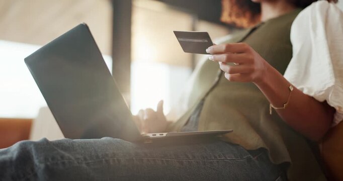 Hands, laptop and woman with credit card for online shopping, payment or purchase in home. Female person, shopper or typing with computer or debit on sofa for ecommerce or banking app in house