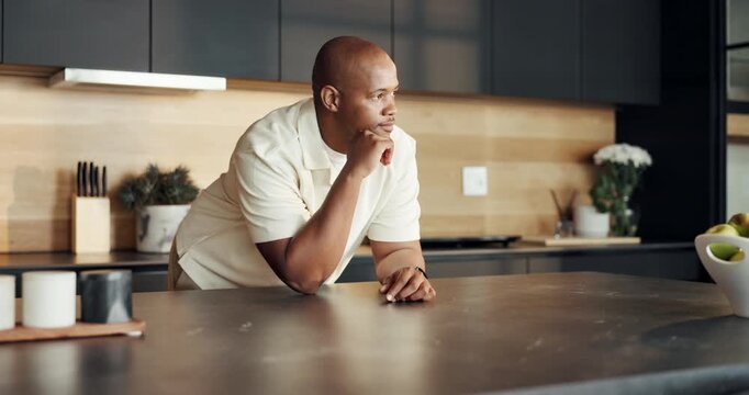 Break, morning and thinking with black man in kitchen of home for ideas, inspiration or vision. Daydreaming, mindfulness and relax with person at counter in apartment for planning or reflection