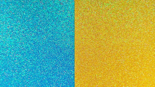 Defocused shimmering azure blue and golden yellow sequin backdrop divided in half. Blue and gold glitter paper background with holographic split texture effect.