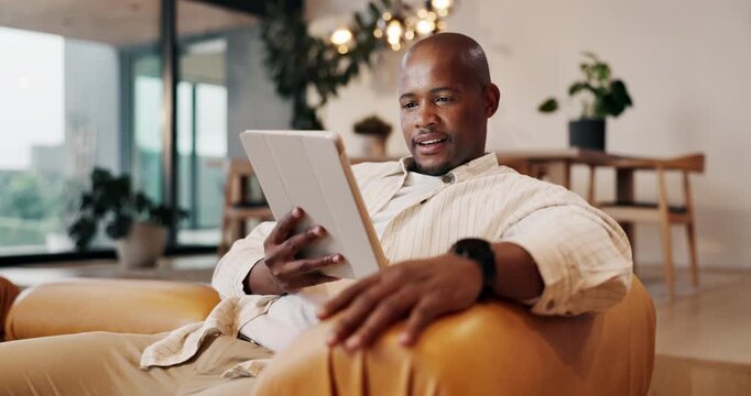 Man, smile and relax with tablet in home, browsing and streaming movies with subscription on website. Black person, online and watching film with tech, scroll and happy with download in lounge