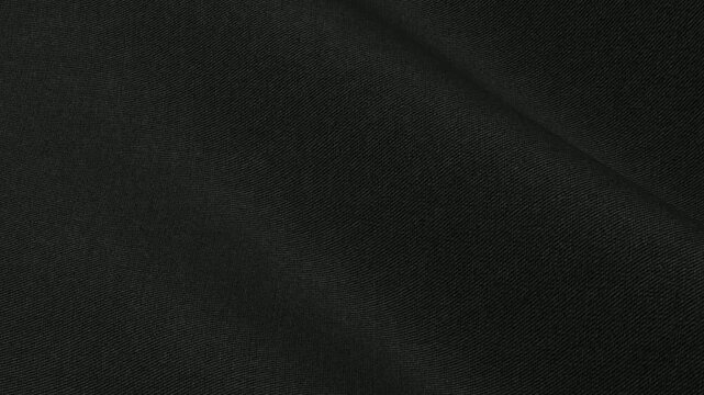 Premium Black Chino Cotton Fabric moving in smooth matte waves of twill weave and heavyweight diagonal texture for durable casual trousers