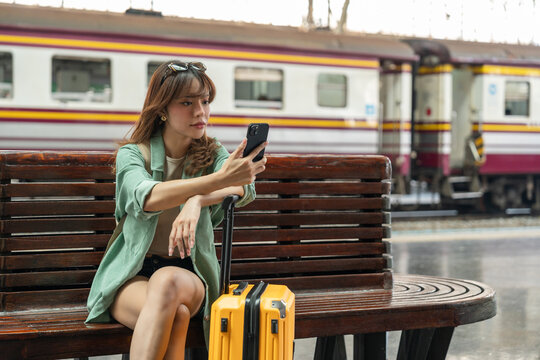 Young woman depressed mistakes a train. Female backpacker Traveler waiting at train station. Boarding the wrong ticket feeling stressed. Planning Fail trip tourist missing