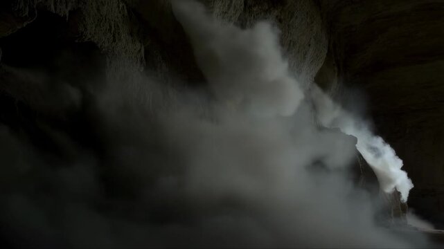Dramatic cave smoke eruption unfurling with mysterious shadows