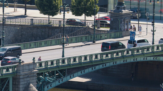 Vehicles and Pedestrians Crossing the Ornate Cech Bridge in Prague