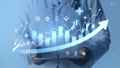 Obraz premium Medical professional holding tablet with rising financial chart and healthcare icons illustrating growth, innovation and progress in modern medical business.