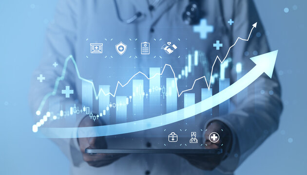 Medical professional holding tablet with rising financial chart and healthcare icons illustrating growth, innovation and progress in modern medical business.