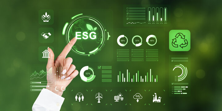 Hand interacting with ESG sustainability hologram interface displaying environmental eco icons and data on glowing green futuristic background.