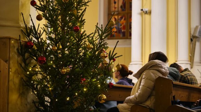 Christmas tree decorating a Catholic Church during a religious service