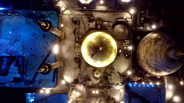 Pure vertical top-down aerial perspective looking directly down onto the shimmering golden dome and architecture of the holy shrine of Lady Masoumeh in Qom city at night stock movies.