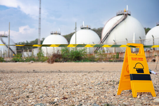 The chemical restricted area is marked with warning signs and hazardous tape during an inspection of hazardous materials at the industrial plant.