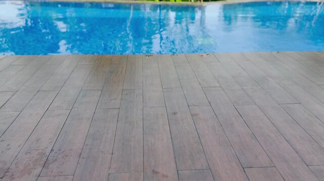 swimming pool with wooden floor deck