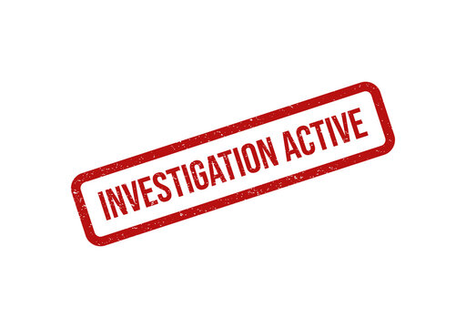 Red ink rubber stamp with the text investigation active on paper