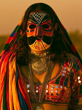 A woman wearing a Rajasthani Kathputli puppet-style painted mask