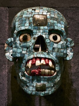 Aztec ceremonial death mask, turquoise mosaic tiles inlaid on skull form, jade and obsidian stones