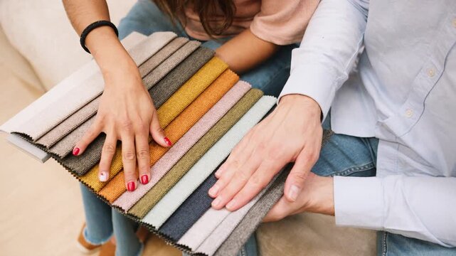 Couple choosing fabric color for new furniture upholstery