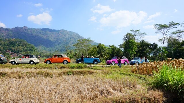 Scenic rural village and mountain landscape under a clear blue sky.