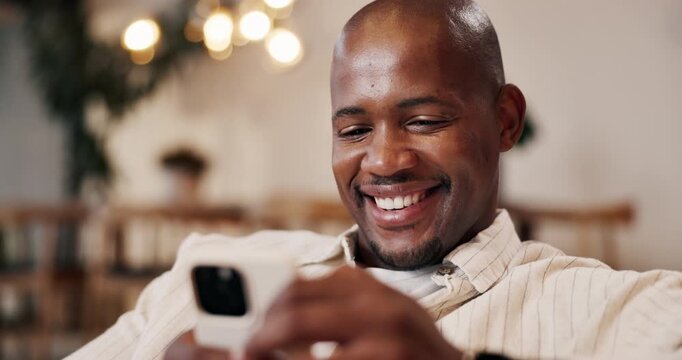 Happy, black man and relax in home with phone, social media and browsing website in living room. Smile, male person or reading at house with mobile, communication and download ebook for weekend break