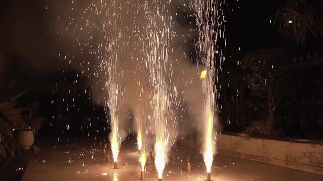Spectacular outdoor fireworks display lighting up the night during a South Asian wedding celebration, Perfect representation of wedding entertainment, celebration, joy, and special event moments.
