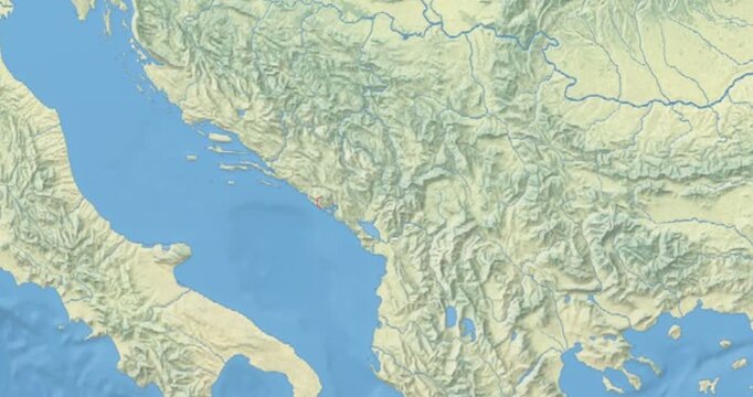 Montenegro on Globe. Zoom into the country with Earth spinning on dark background. Physical world map with Montenegro and label on it. Country view animation.