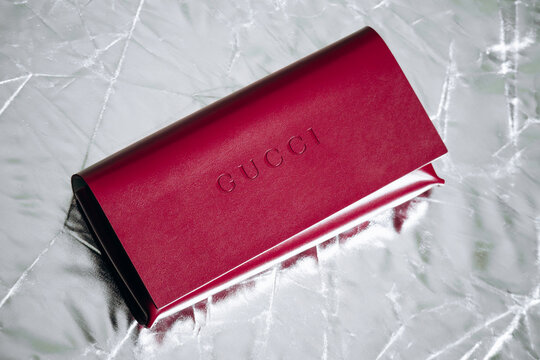 Nice, France - March 1, 2026: Red Gucci leather eyeglasses case photographed in a studio setting, featuring embossed Gucci branding, smooth leather finish and luxury accessory craftsmanship