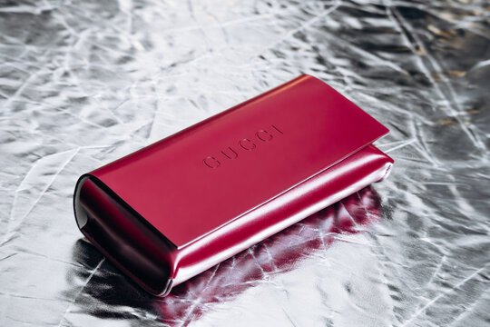 Nice, France - March 1, 2026: Red Gucci leather eyeglasses case photographed in a studio setting, featuring embossed Gucci branding, smooth leather finish and luxury accessory craftsmanship