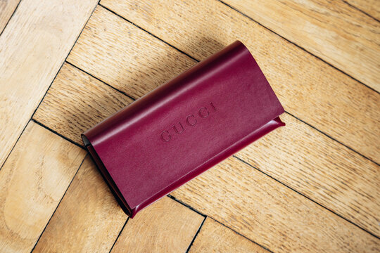 Nice, France - March 1, 2026: Red Gucci leather eyeglasses case photographed in a studio setting, featuring embossed Gucci branding, smooth leather finish and luxury accessory craftsmanship